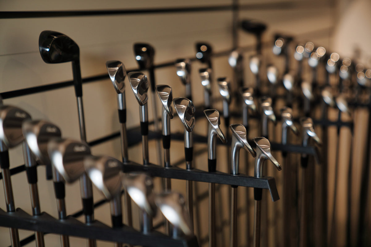 Close-up of premium Mizuno golf clubs at the Club Fitting Centre inside Noosa Golf Co., a leading Noosa and Sunshine Coast golf shop offering custom fit gear and expert fitting services.
